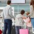 Family with children and suitcases at the airport ready for an airport transfer with Arrivals Star Taxis.